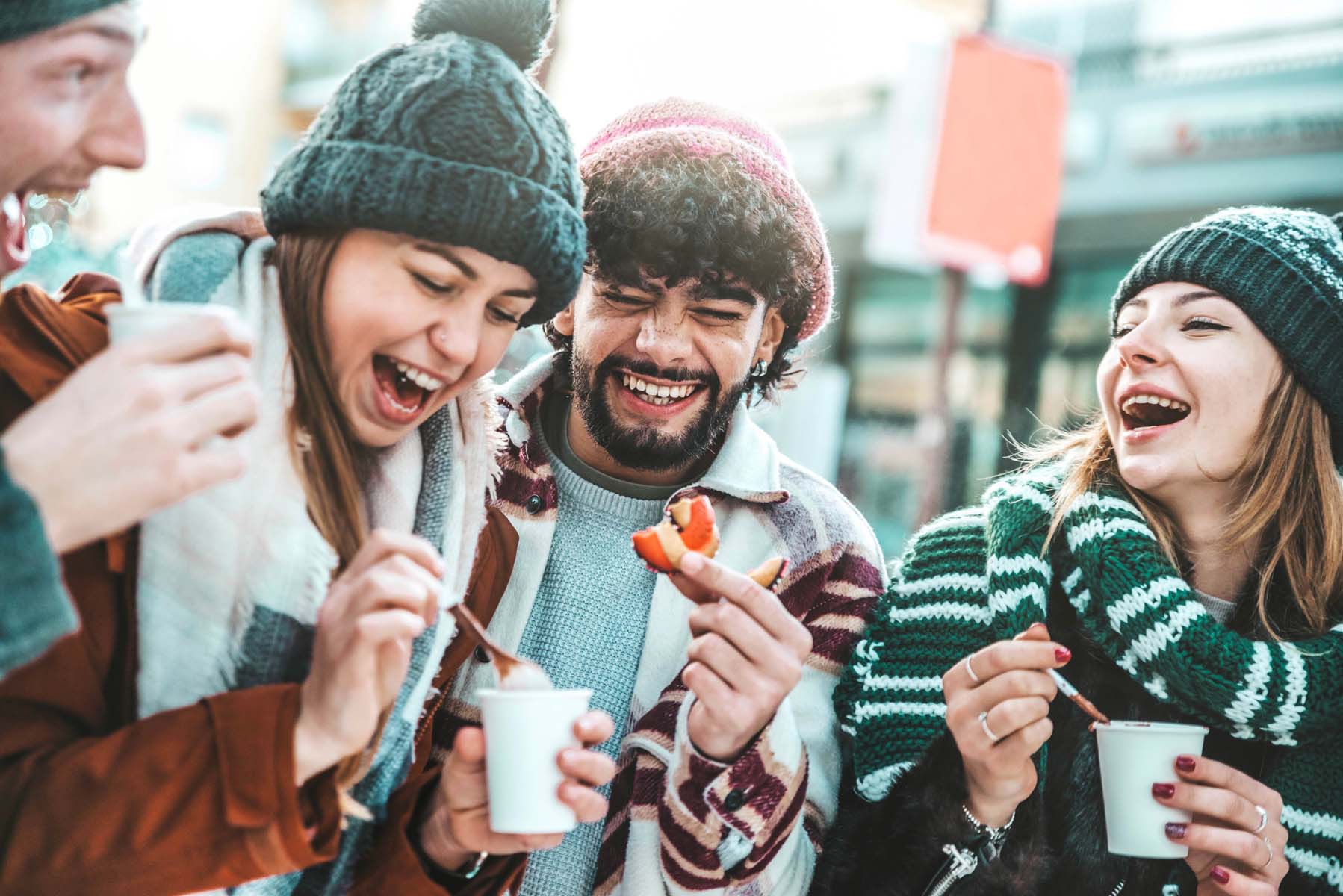 Happy,Friends,Having,Fun,Drinking,Mulled,Wine,And,Hot,Chocolate A happy couple taking a selfie in front of the famous liberty bridge during summer in Budapest in Hungary