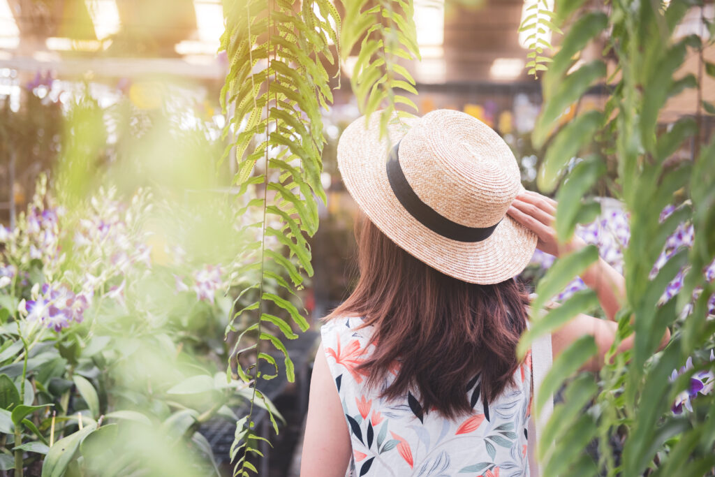 Young woman walking in the orchid garden