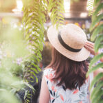 Young woman walking in the orchid garden